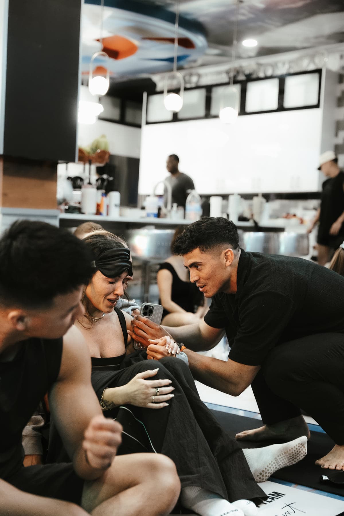 Jovany Ruiz kneeling beside a participant, offering support after breathwork